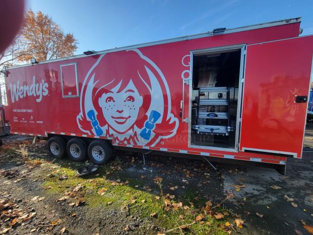 2021 Titanium 28' food trailer, red exterior, custom-built, pristine condition. Professional-grade unused interior visible.