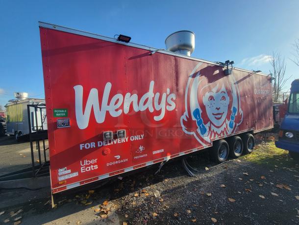 2021 Titanium 28' food trailer, high-capacity, pristine condition, custom-built, unused professional-grade equipment, factory protective material visible.