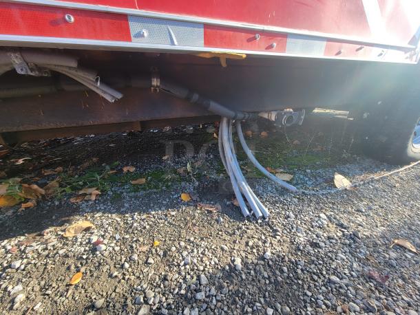 Underside of a 2021 Titanium 28' food trailer, showing new, unused condition with intact piping and clean exterior.
