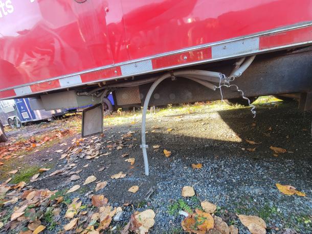 Red Titanium 28' food trailer underbody, pristine condition, 2021 model. Features unused pro-grade equipment.