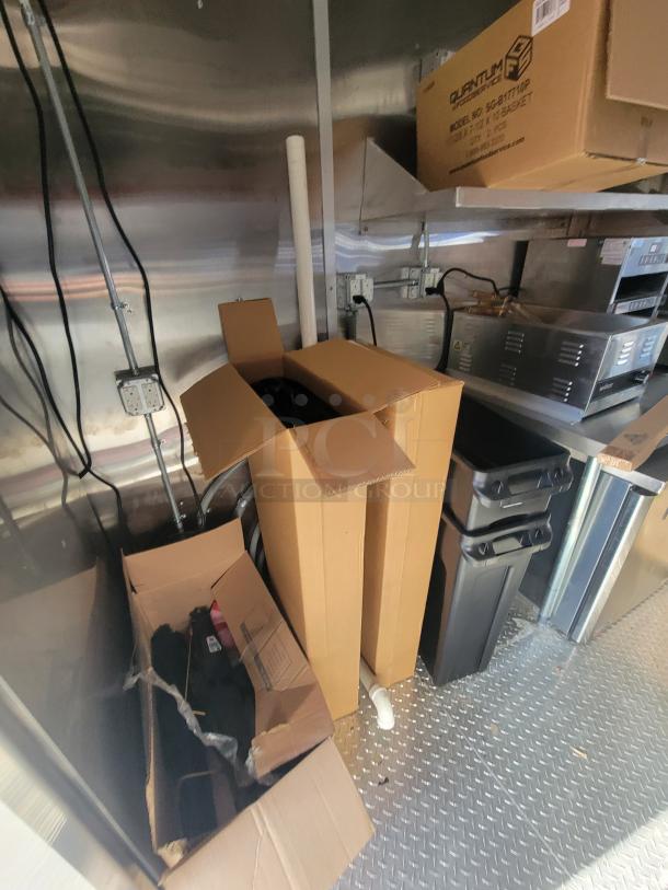 Pristine 2021 Titanium 28' food trailer interior. Unused professional-grade equipment with visible factory protective material.