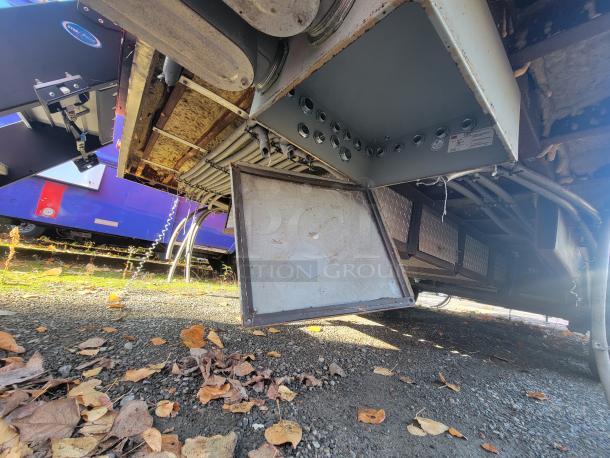 Underside view of a pristine 2021 Titanium 28' food trailer, showing unused equipment and factory protective materials.