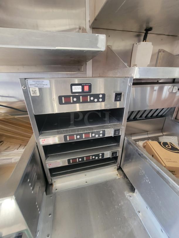 As-new 2021 Titanium 28' food trailer interior. Unused, fully-equipped with factory protective materials visible. Professional-grade.