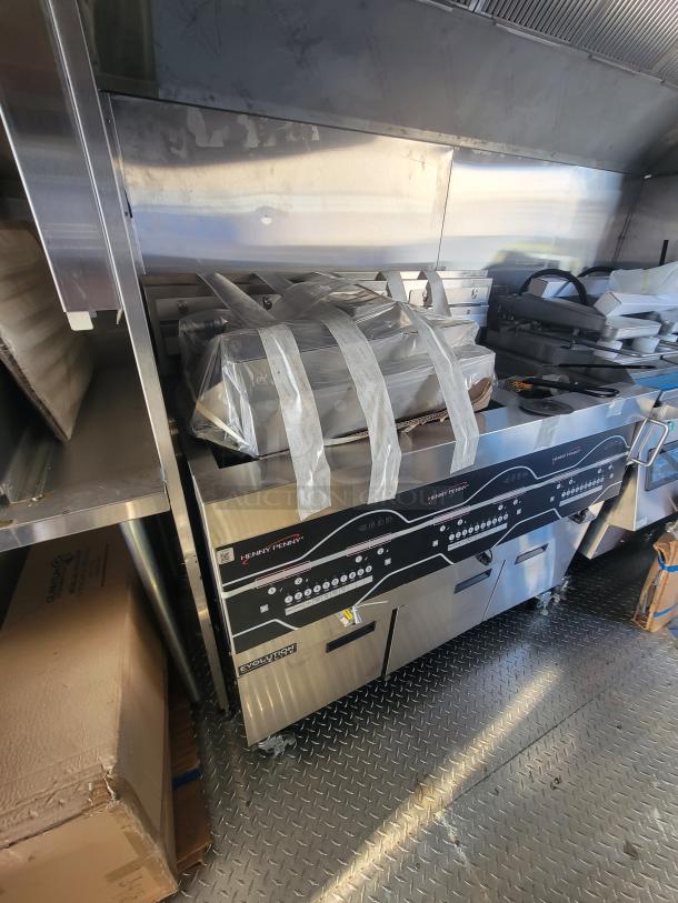 Pristine 2021 Titanium 28' food trailer interior with unused professional equipment, protective materials visible.