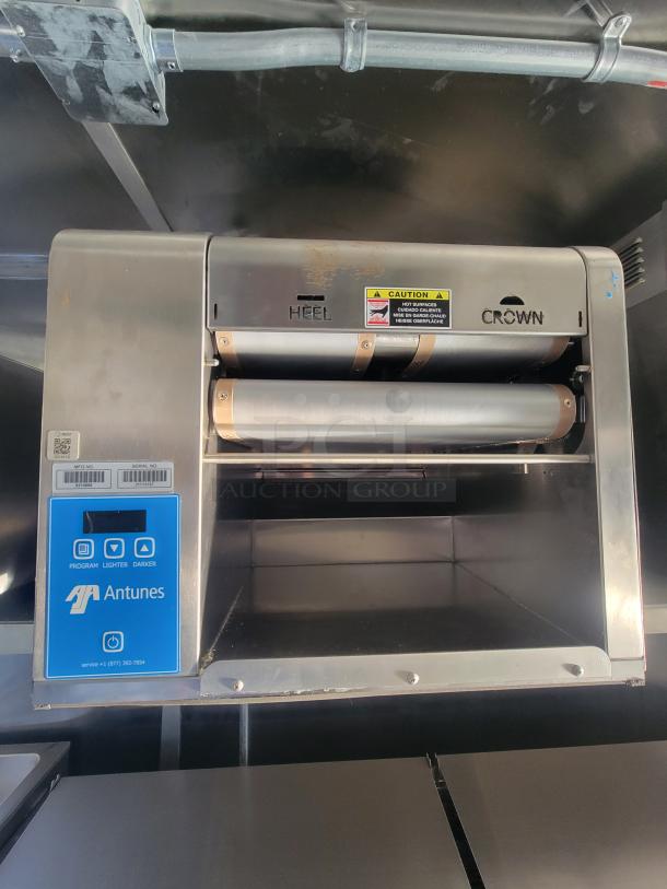 Industrial toaster inside a 2021 Titanium 28' food trailer, featuring Antunes controls and new, unused equipment with factory protection.