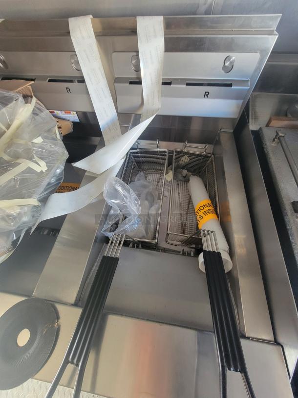 2021 Titanium 28' food trailer interior showing unused professional-grade fryers with protective materials intact.