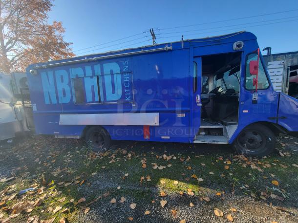 Blue 2003 Chevrolet P24 Workhorse food truck with professional kitchen build-out, "NBRHD Kitchens" branding, turnkey ready.