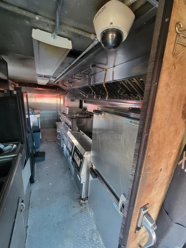 2003 Workhorse diesel food truck interior, featuring a custom-built commercial kitchen with stainless steel appliances.