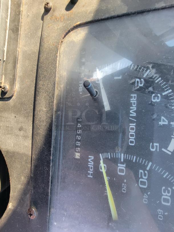 Close-up of a 2003 Workhorse food truck speedometer, indicating 145,285.5 miles. Partially rusted dashboard visible.