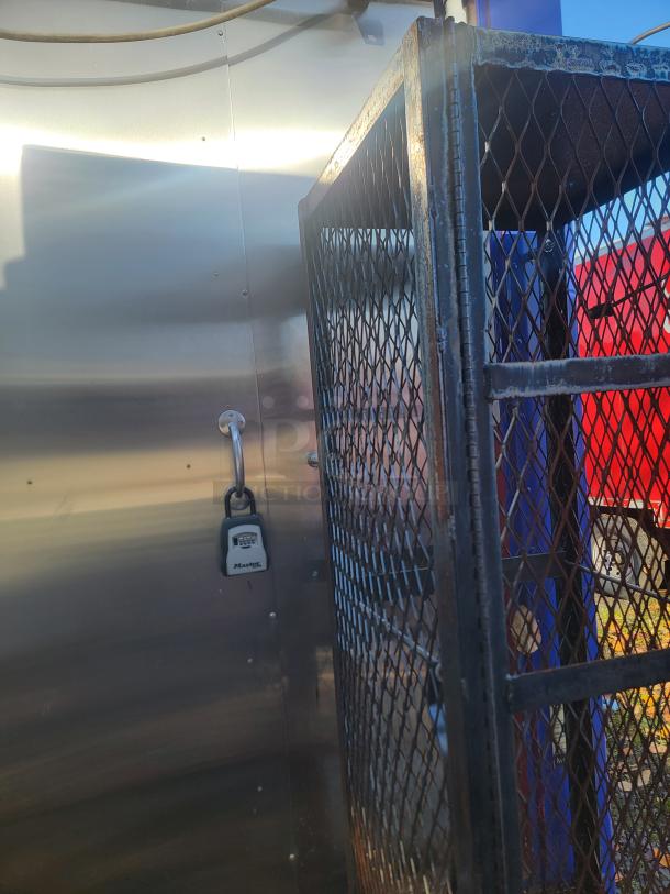 2003 Workhorse Diesel Food Truck interior. Features stainless steel wall, lockbox, and protective metal cage. High-quality commercial kitchen build-out.