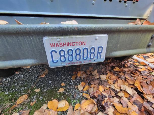Rear view of a 1973 International Step Van showing its license plate "C88808R" from Washington, Evergreen State.
