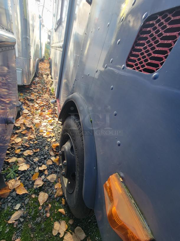 1973 International Step Van with visible side panel, featuring smoke/fire damage. As-is mobile unit for salvage or restoration.
