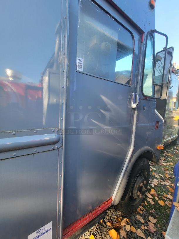 1973 International Step Van with fire damage, featuring potential salvageable commercial kitchen equipment, as-is condition.