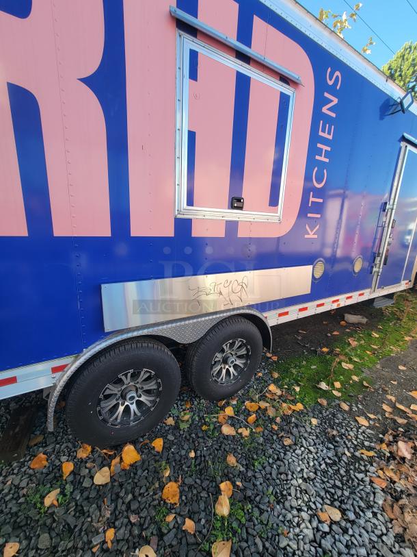 2021 24' Quality Trailer, blue and pink exterior, high-capacity electric kitchen, dual axles, like new condition.