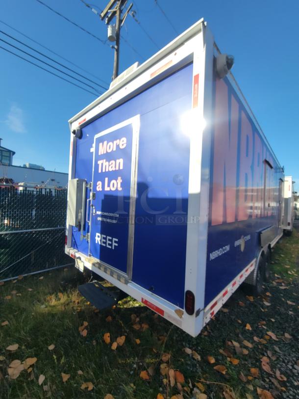 2021 Quality 24' trailer with electric kitchen, blue exterior, "More Than a Lot" text, ideal for high-volume food service.