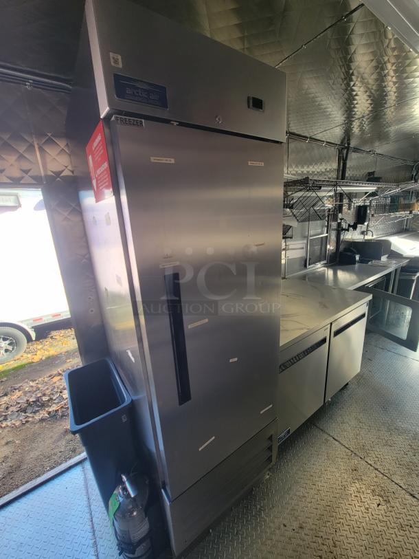2021 Quality 24' trailer interior with Arctic Air freezer, commercial kitchen equipment, stainless steel surfaces, pristine condition.