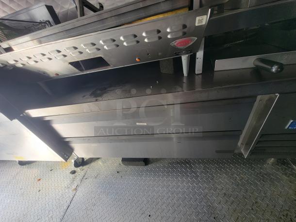 2021 Quality 24' trailer with commercial electric kitchen, stainless steel appliances, and durable flooring, in excellent condition.