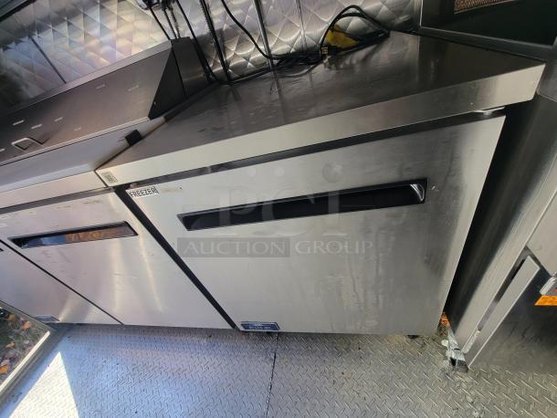 2021 Quality 24' trailer interior showing stainless steel commercial freezers, labeled for electric kitchen use, pristine condition.