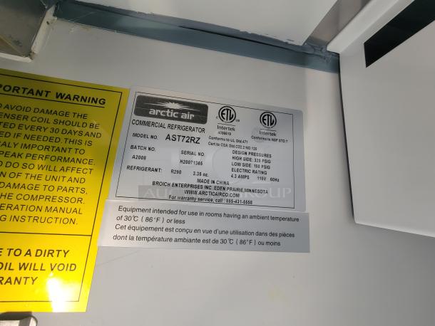 Label inside a trailer showing an Arctic Air commercial refrigerator, model AST72RZ, with specifications and warning notes.