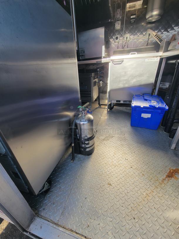 2021 Quality 16' food trailer interior, equipped with commercial appliances including Vulcan stove and Arctic Air fridge.