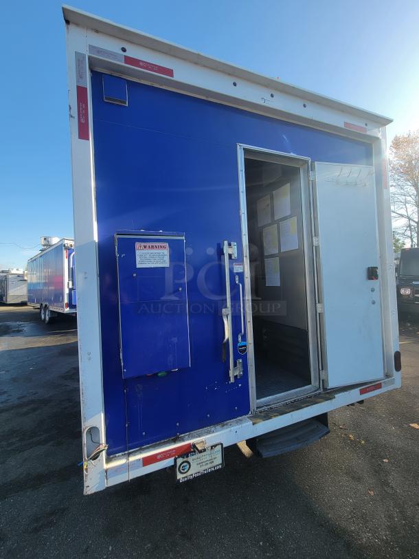 High-end 2021 16' Quality food trailer, blue exterior, open door shows interior. Warning signs and Quality manufacturer tag visible.