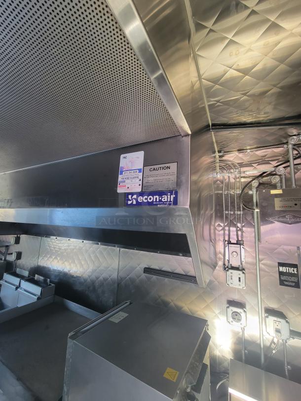 16' Quality food trailer interior, featuring stainless steel appliances, econ-air ventilation, and safety notices. Mint condition.