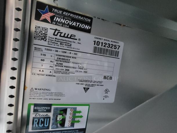 Label on high-end food trailer equipment, featuring a True Refrigeration model TSSU-36-12M-B-HC with compressor EMI90UEX, refrigerant R290. Serial number 10123257.