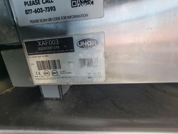 UNOX label on commercial kitchen equipment, model XAF003, made in Italy. Shows specifications and safety certifications.
