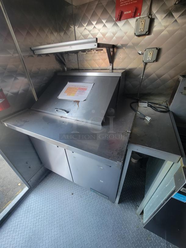 16' Quality food trailer interior, featuring Vulcan & Arctic Air equipment. Stainless steel surfaces, power outlets visible.