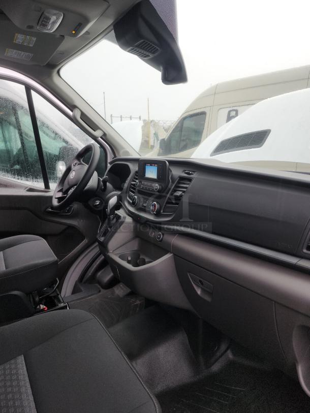 Interior of 2020 Ford Transit 350 Cargo Van, showing clean dashboard, steering wheel, and upholstery; low mileage vehicle.