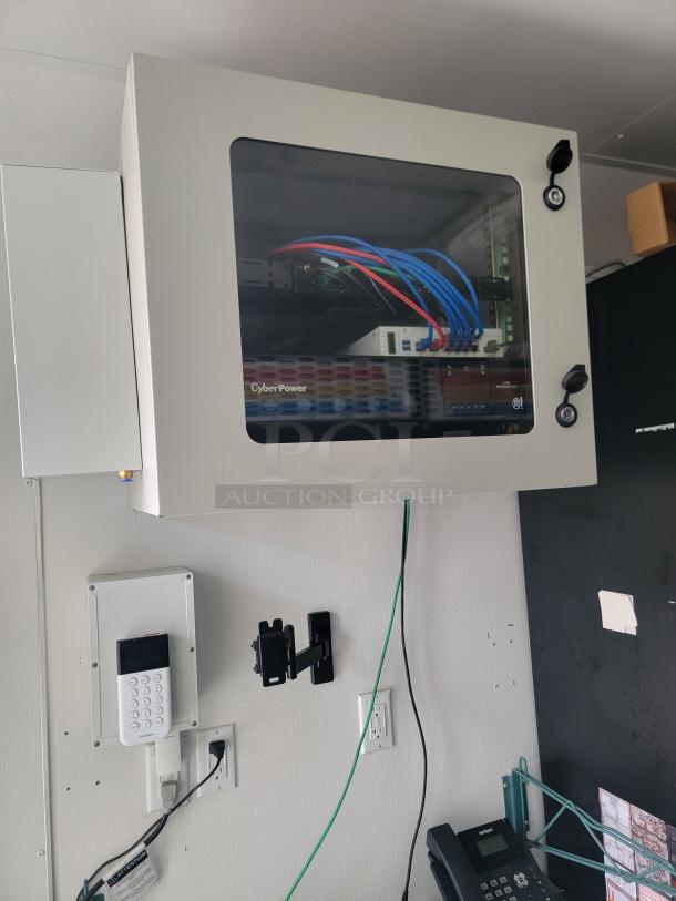 Electrical panel and CyberPower equipment inside a 2021 SDG 8.5' x 20' food concession trailer, showing professional wiring setup.