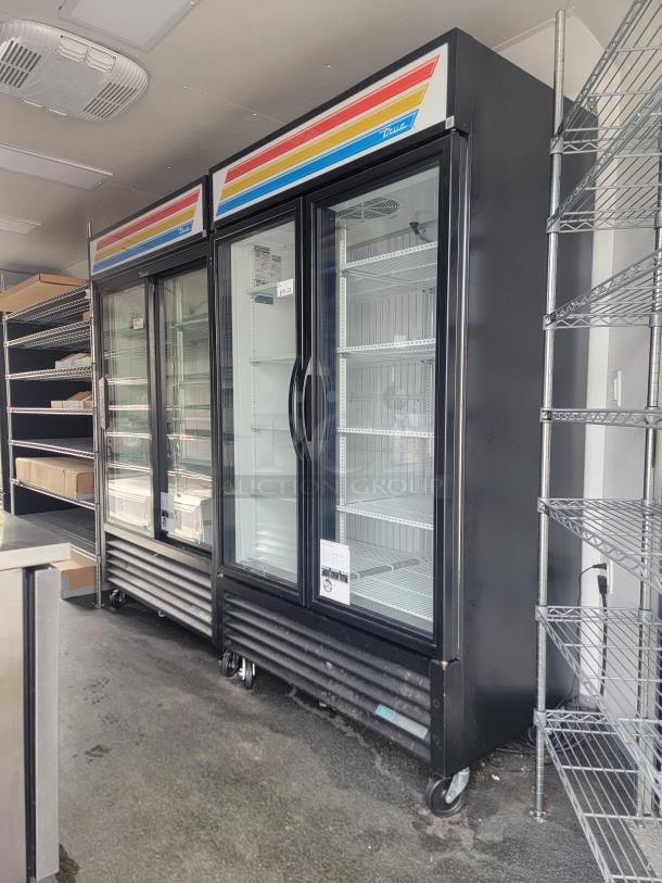 2021 SDG 8.5' x 20' food concession trailer interior with True refrigeration units and shelving, ready for frozen goods sales.