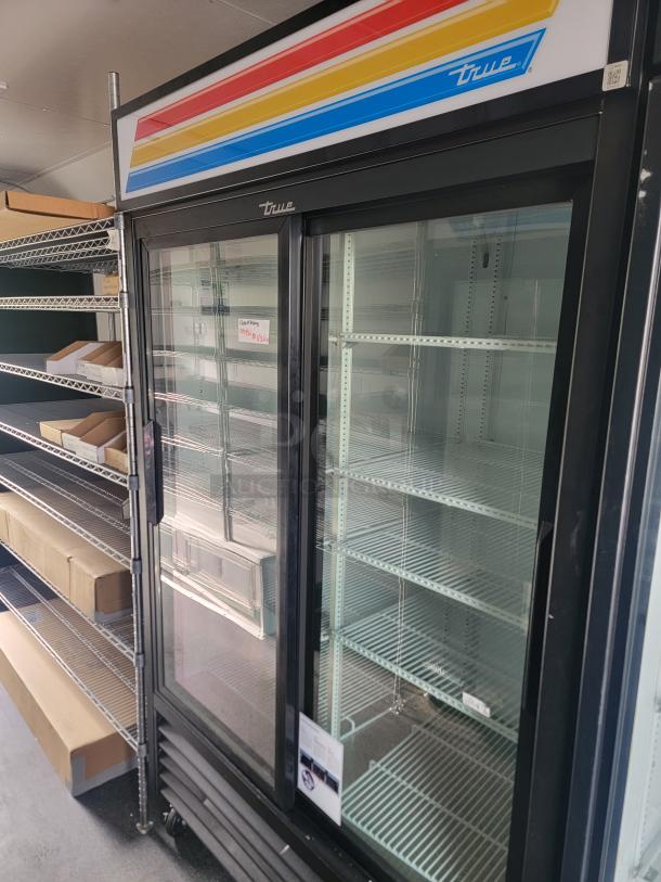 Southern Dimensions Group 2021 food concession trailer interior with True brand display fridge and wire shelving.