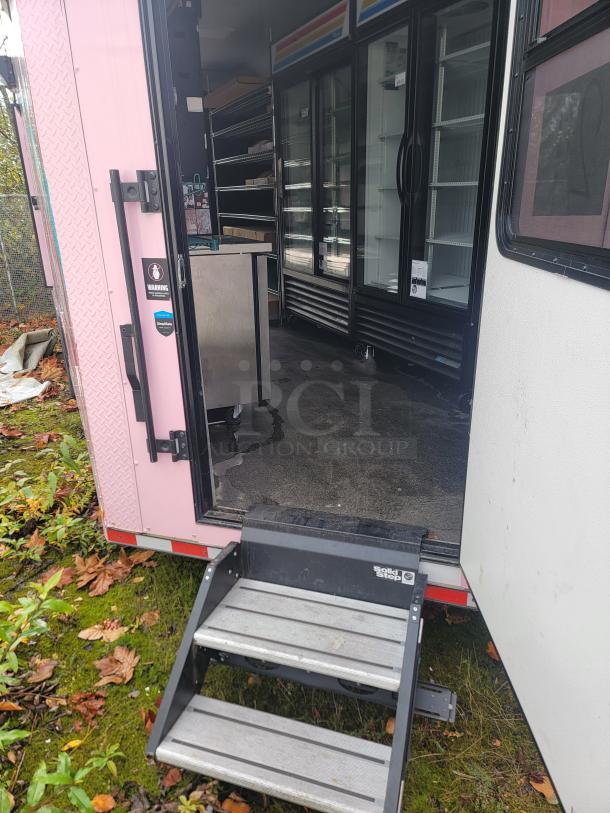 2021 SDG 8.5' x 20' concession trailer interior showing shelving and refrigerators, solid steps for entry.