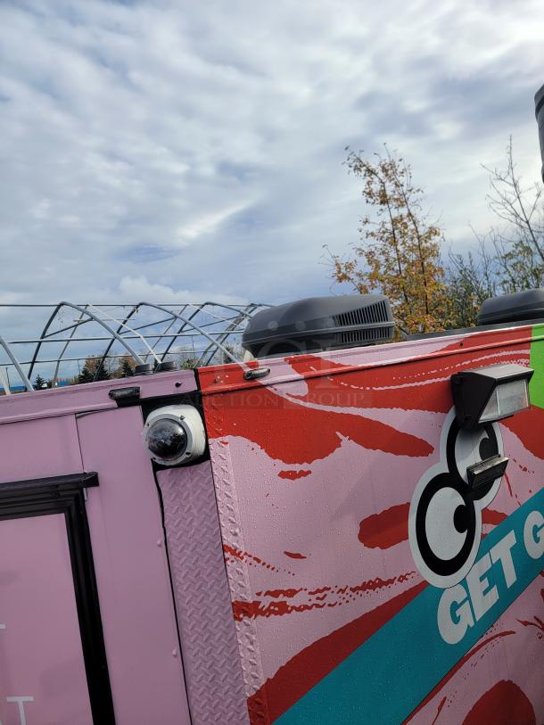 2021 SDG 8.5x20 tandem axle food concession trailer with vibrant wrap and modern equipment for selling frozen goods.