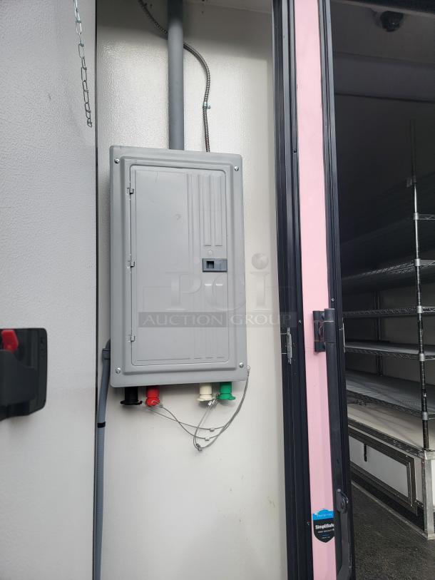 Interior view of 2021 SDG 8.5' x 20' food trailer, showing electrical panel and shelving. Ready for concession use.