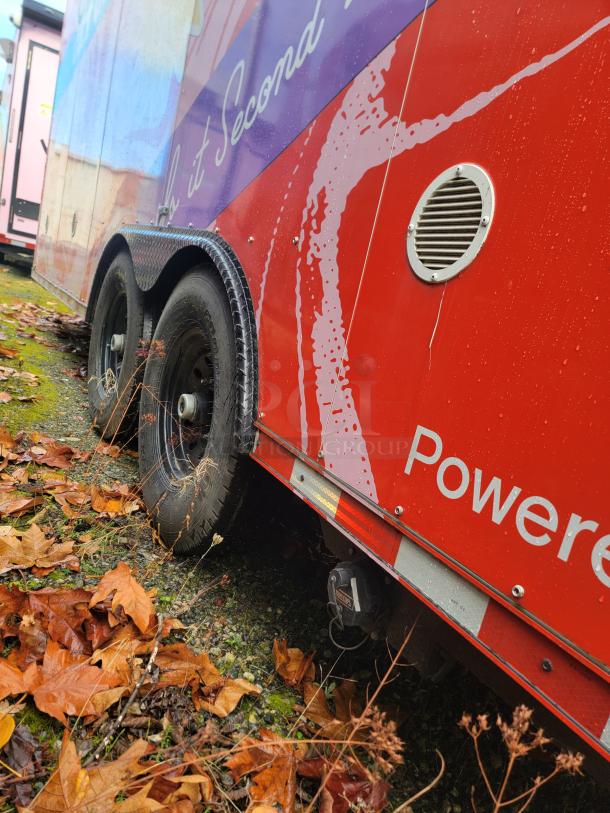 2021 SDG 8.5' x 20' Food Concession Trailer, vibrant wrap, tandem axle, mint condition, designed for dessert sales.