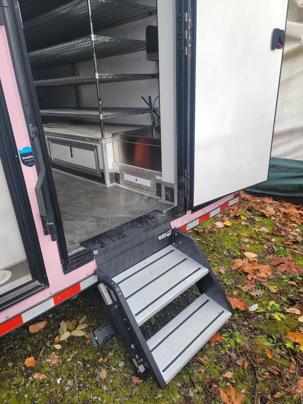 2021 SDG 8.5' x 20' food concession trailer, interior metal shelving, entry steps, stainless steel equipment, pristine condition.