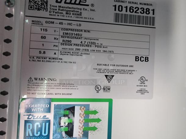 Label on the True Manufacturing refrigeration unit model GDM-45-HC-LD; indicates compressor details and safety warnings.