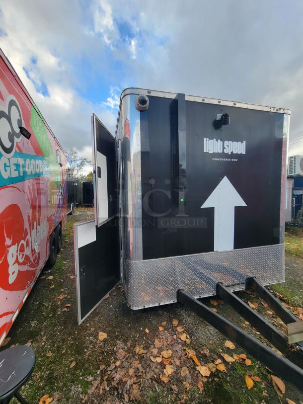 2021 24' Diamond Cargo Mobile Kitchen Trailer, black exterior, labeled "light speed," side entrance door open.