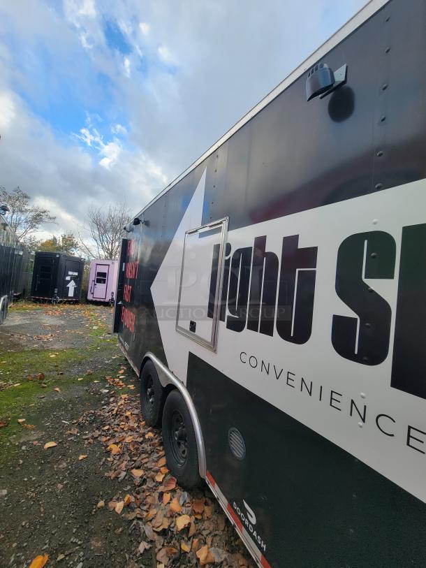 2021 24' Diamond Cargo mobile kitchen trailer, black exterior, side branding, tandem axle.