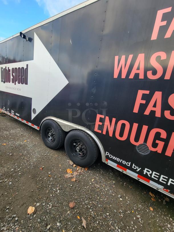 24' Diamond Cargo trailer, 2021 model, black exterior with branding, dual axles, ready for mobile kitchen use.