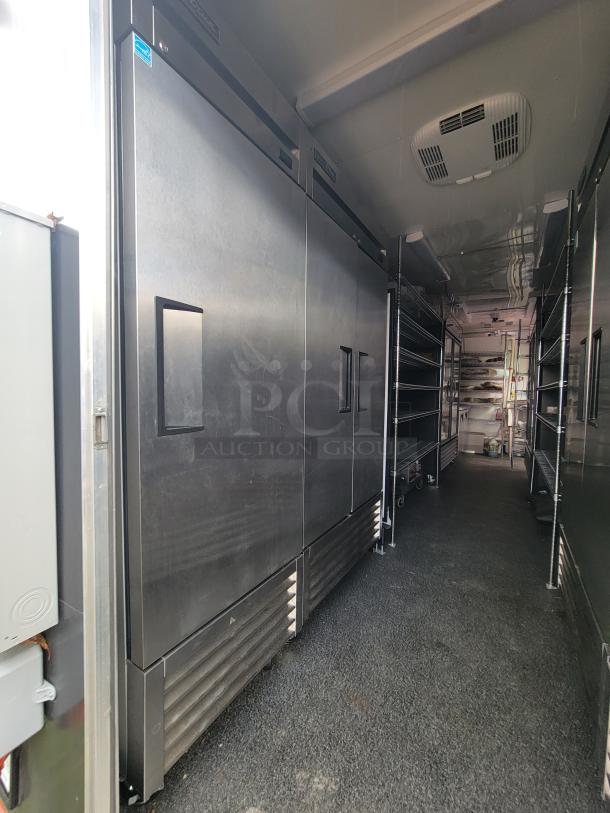 2021 24' Diamond Cargo mobile kitchen trailer interior with stainless steel appliances and ample shelving.