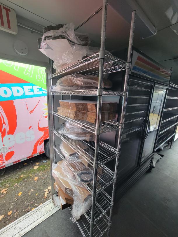 2021 Diamond Cargo 24' mobile kitchen trailer interior with shelving and refrigeration units. Fully equipped for turnkey operation.