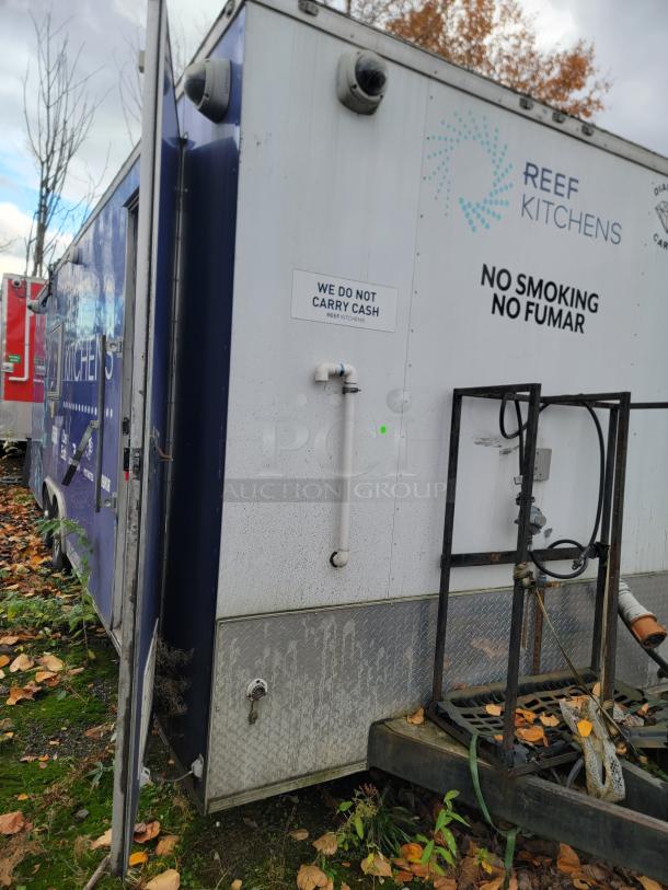 2019 24' Rock Solid Cargo commercial food trailer, marked "REEF Kitchens." Features security cameras and "No Smoking" sign.