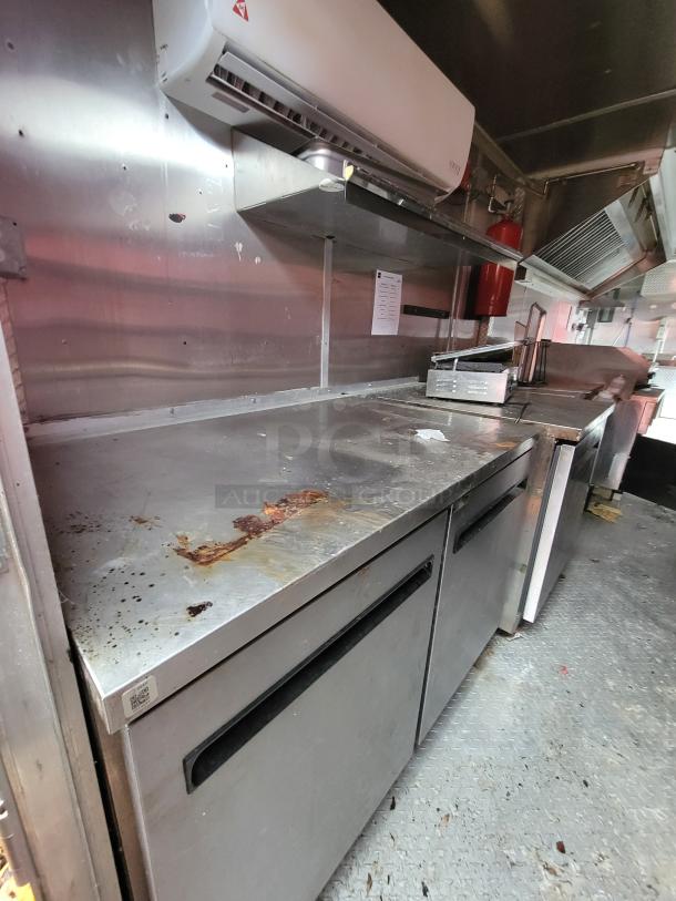 2019 Rock Solid Cargo 24' food trailer interior. Features stainless steel prep surfaces, Mini-Split HVAC, and commercial kitchen equipment.