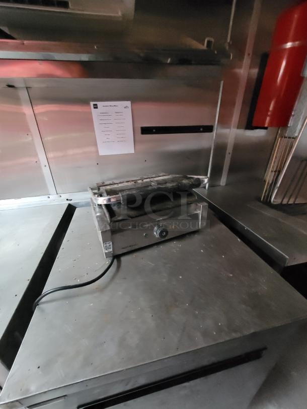 2019 Rock Solid Cargo 24' food trailer interior. Features stainless steel surfaces, equipment racks, and fire extinguisher.