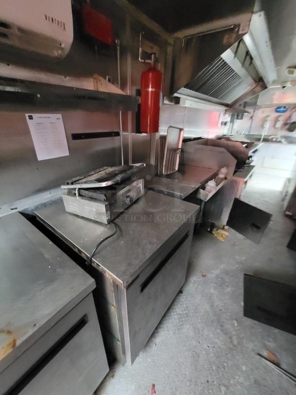2019 24' Rock Solid Cargo food trailer interior with stainless steel cookline, Arctic Air units, and fire suppression system.