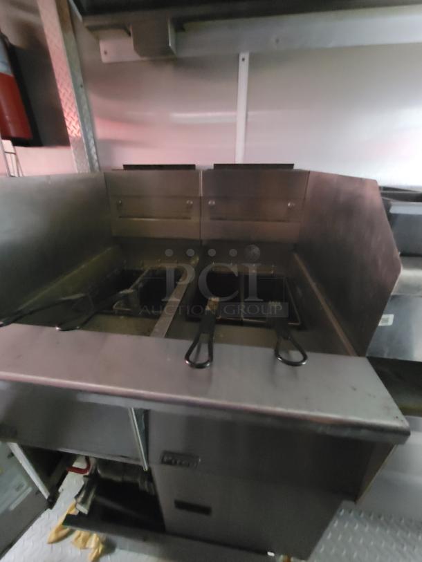 2019 Rock Solid food trailer interior with gas deep fryer, part of a turnkey kitchen setup, featuring durable stainless steel construction.