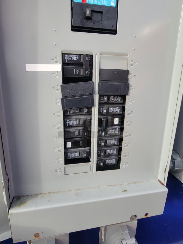 Electrical panel in 2021 Quality 16-foot kitchen vessel, displaying circuit breakers, labeled positions, dual-axle power system.